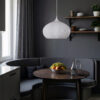 Person holding a white pendant lamp.