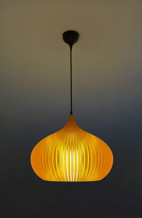 Person adjusting amber lampshade indoors