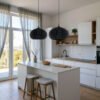 Oval black pendant lights over kitchen island