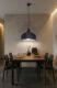 Carbon Black UMBRA pendant lampshade hanging over a kitchen island, volcanic texture exterior