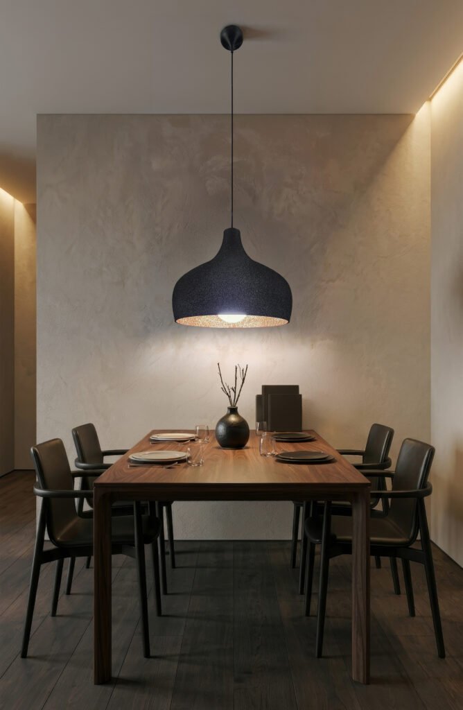 Carbon Black UMBRA pendant lampshade hanging over a kitchen island, volcanic texture exterior