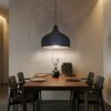 Carbon Black UMBRA pendant lampshade hanging over a kitchen island, volcanic texture exterior